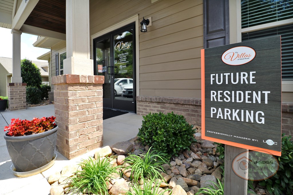 A sign in front of a the clubhouse that reads "future resident parking."