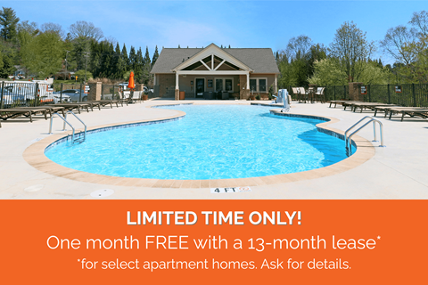 A pool with a sign offering a free month with a 13-month lease for select apartment homes.