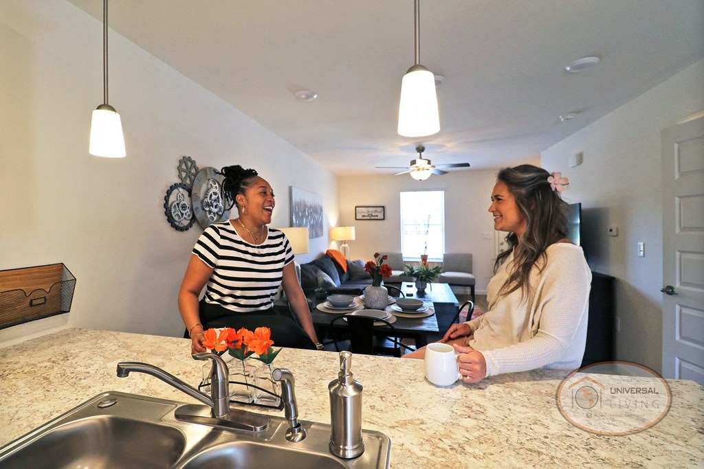 two women in a kitchen talking to each other