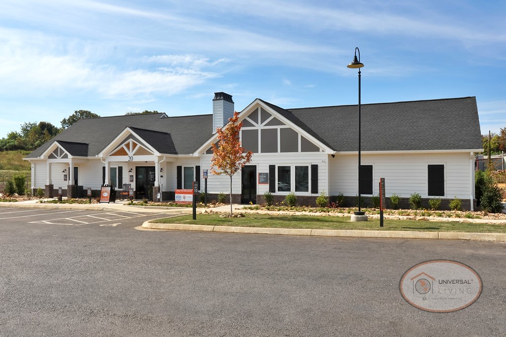 The front of the white and grey clubhouse and leasing office.