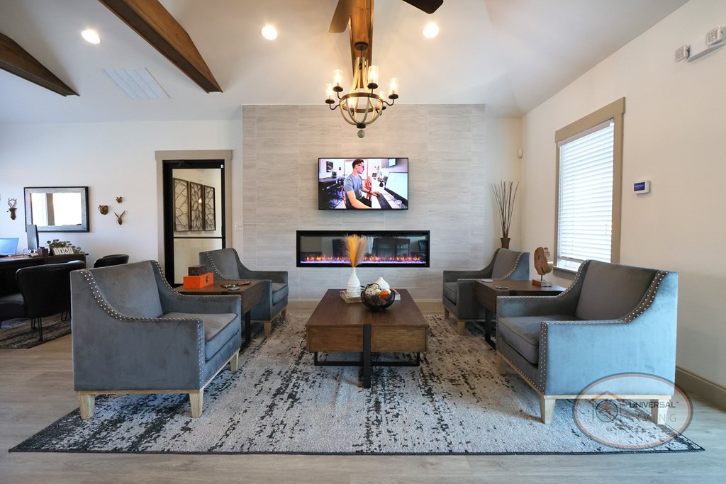 The clubhouse lounge with flat screen TV, fireplace, and lounge seating.