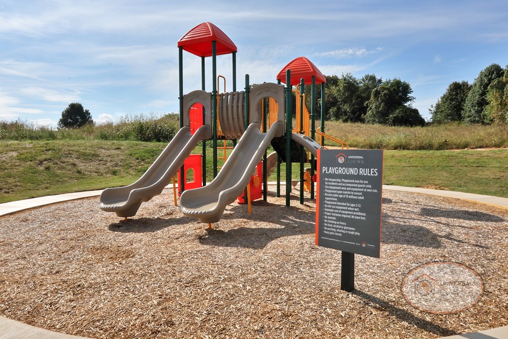 A soft topped playground with slides and jungle gym.