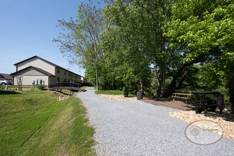 A gravel walking path that goes through the community along the river.