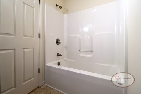 A white bathroom with a tub and shower.