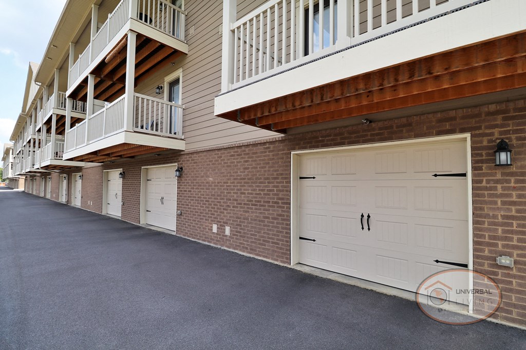 A row of garages with balconies above them.