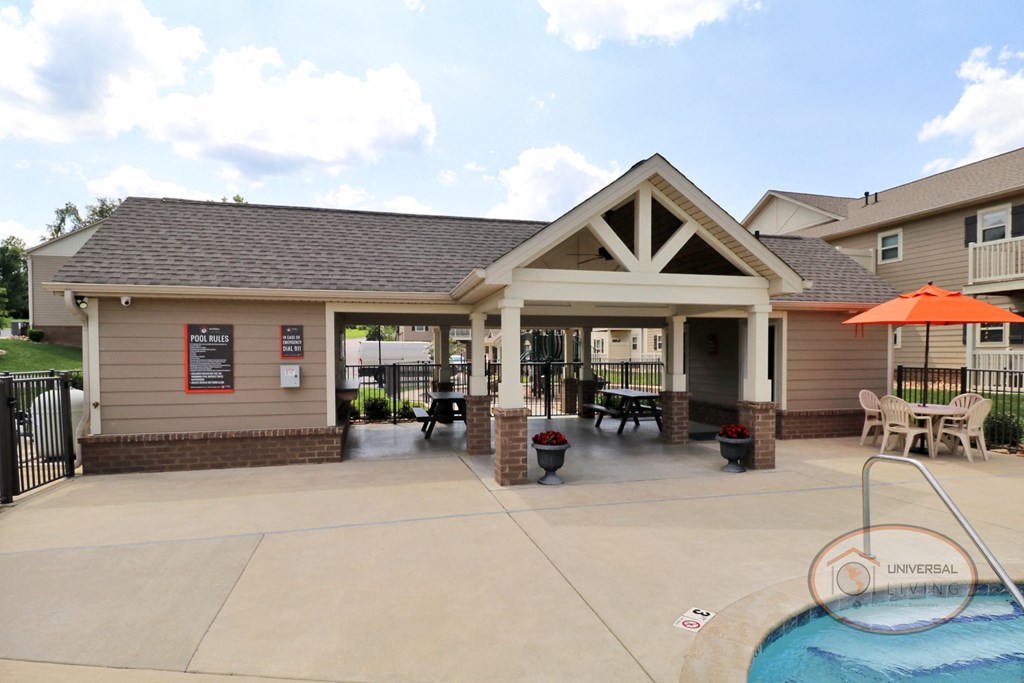 The poolside patio, complete with picnic tables and a ceiling fan.