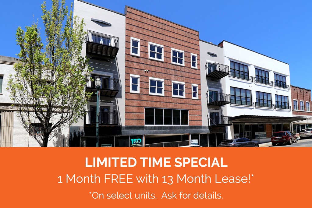 The Henry on Main, Apartment Homes in Johnson City, Tennessee Special Offer The front of a downtown brick apartment building with an orange banner reading "LIMITED TIME SPECIAL: 1 Moth FREE with 13 Moth Lease!* *On select units. Ask for details."