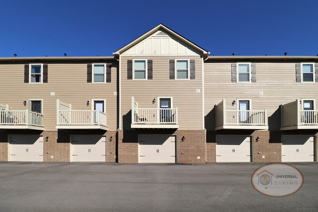 A close up view of a garage exterior with balconies above.