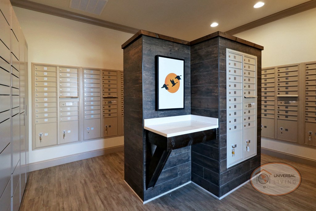 The mail center with rows of mail boxes and a small table.