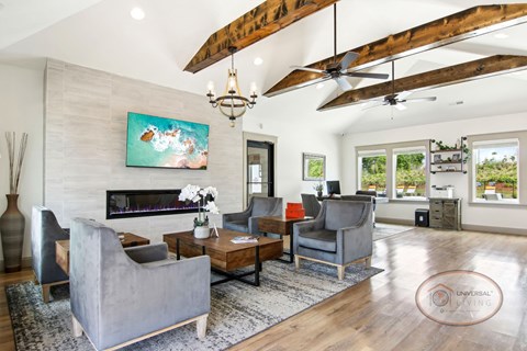 A living room with a grey couch, a wooden coffee table, and a painting on the wall.