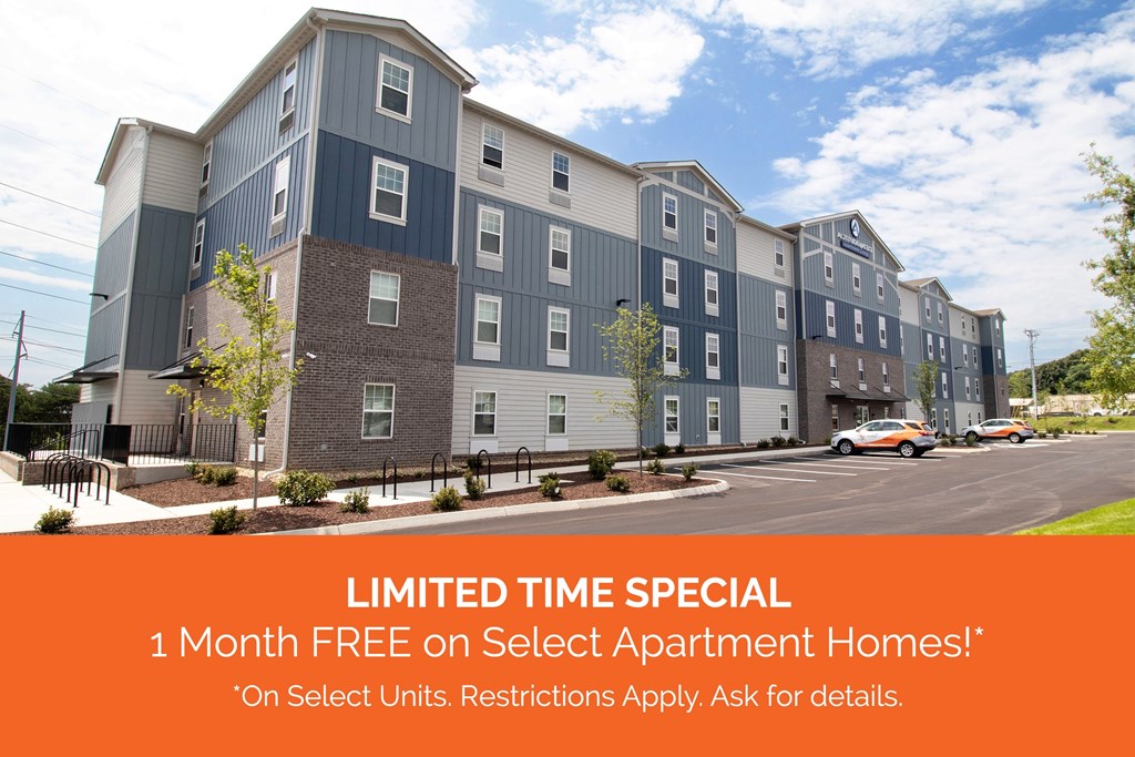 Altitude@6313 in Knoxville, TN Apartment Homes Special Offer Discount A blue and white apartment building with brick accents and an orange banner that reads "LIMITED TIME SPECIAL: 1 Month FREE on Select Apartment Homes!* *On Select Units. Restrictions Apply. Ask for Details."