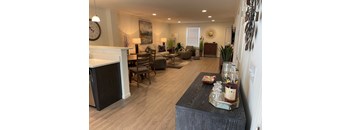 a kitchen and living room with a large clock on the wall