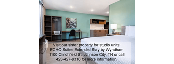 A room with a desk and a chair is shown with text advertising ECHO Suites Extended Stay by Wyndham.