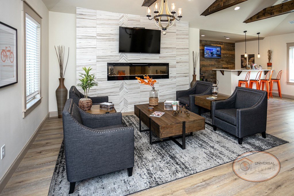 a living room with chairs and a table and a fireplace