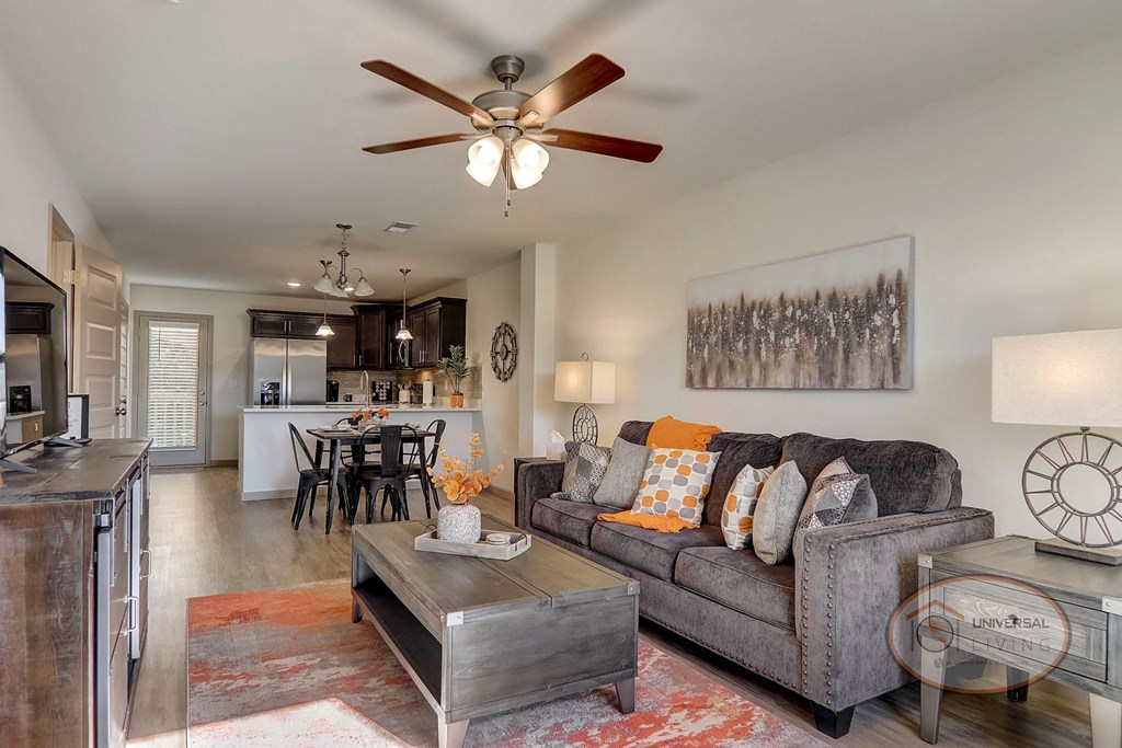 a living room with a couch and a ceiling fan