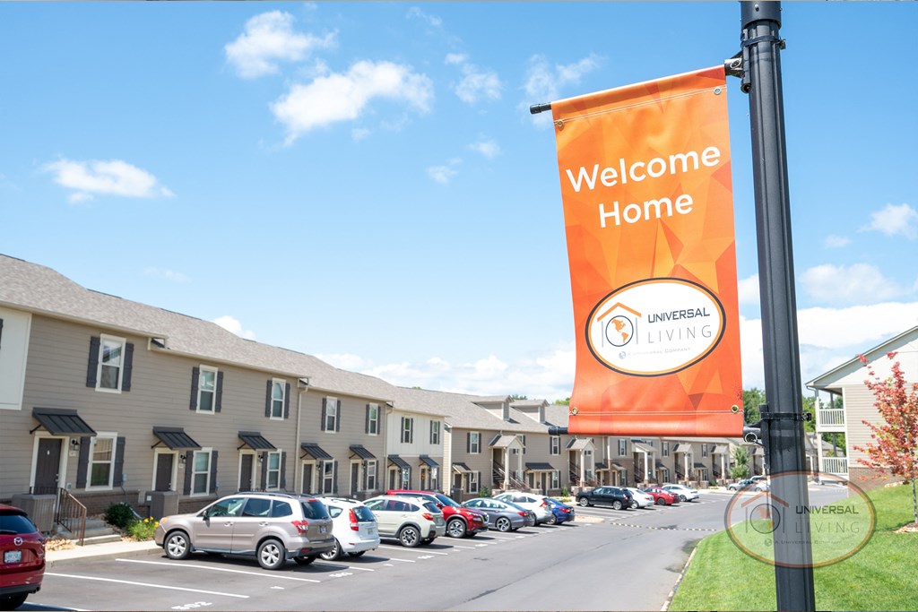 a banner that reads welcome home in front of a parking lot