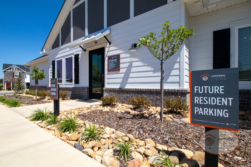 a white building with a sign that reads future resident parking