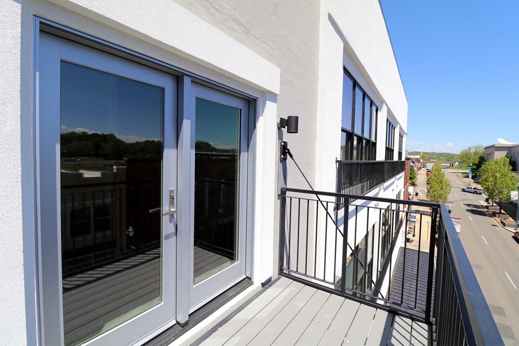 A balcony with glass doors overlooking downtown Johnson City, Tennessee.