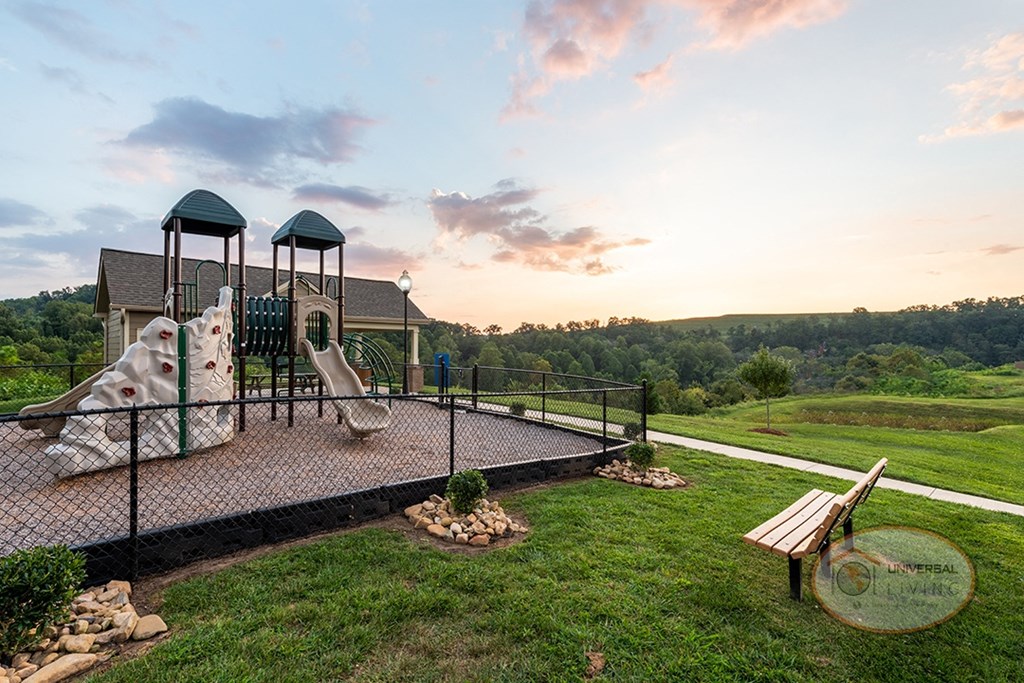 A soft topped playground with slide and jungle gym.