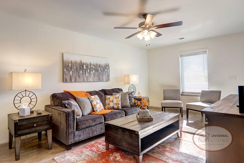 a living room with a couch and a ceiling fan