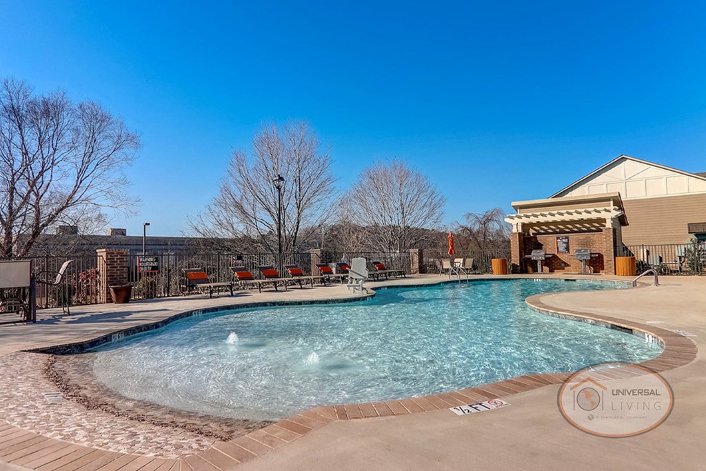 a resort style pool with a building in the background