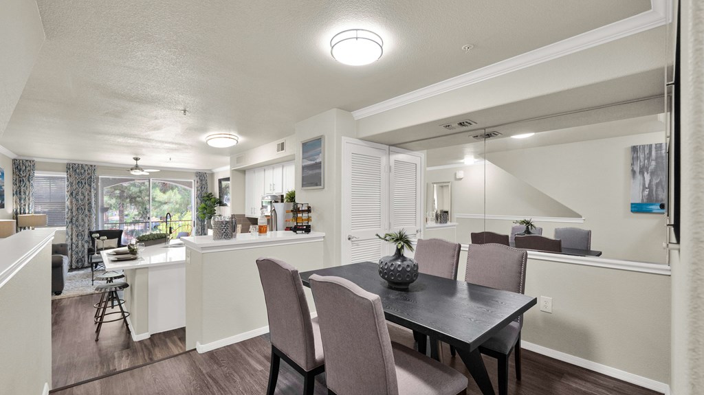 A dining room with a table and chairs.