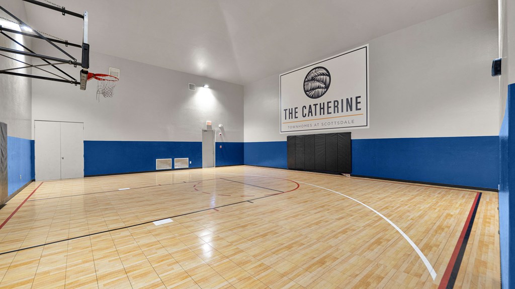 A basketball court with a sign that says "The Catherine".