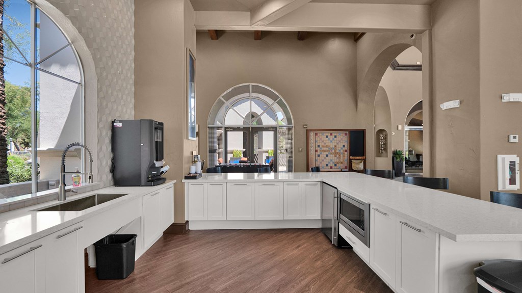 A kitchen with a large island and a refrigerator.