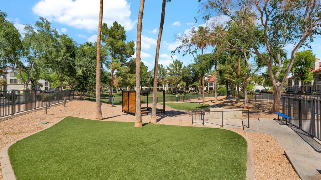 A park with a green lawn and a playground.