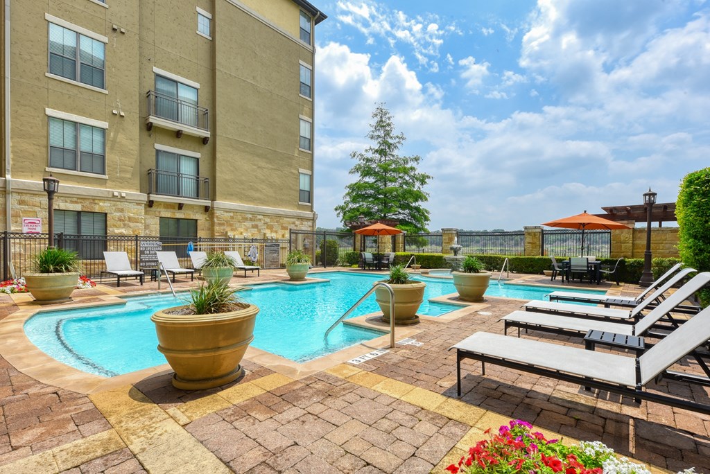 our apartments have a resort style pool and lounge chairs