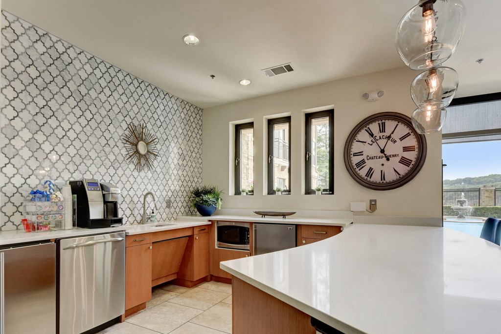 a large kitchen with a large clock on the wall
