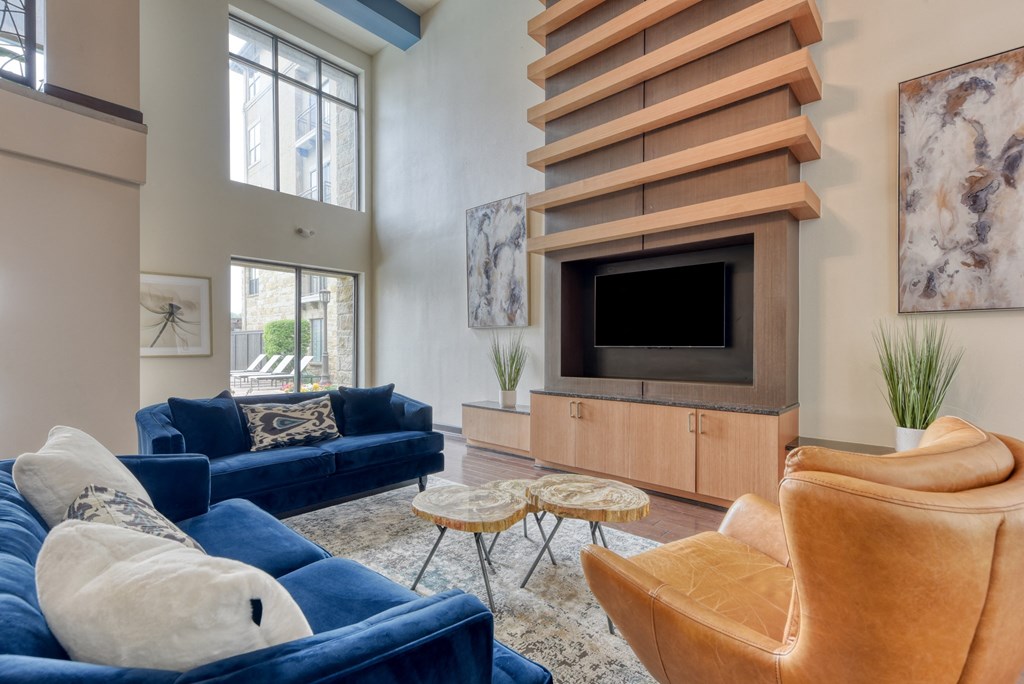 a living room with couches and chairs and a television