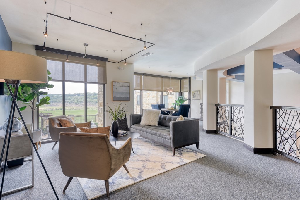a living room with couches and chairs and a balcony