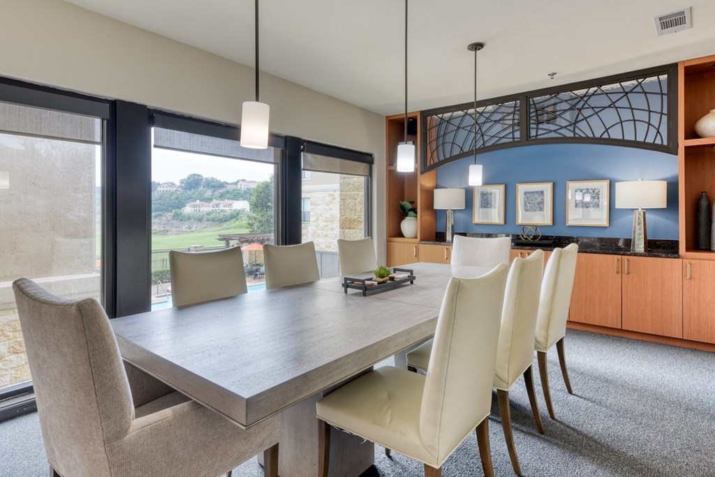 a dining room with a long table and chairs