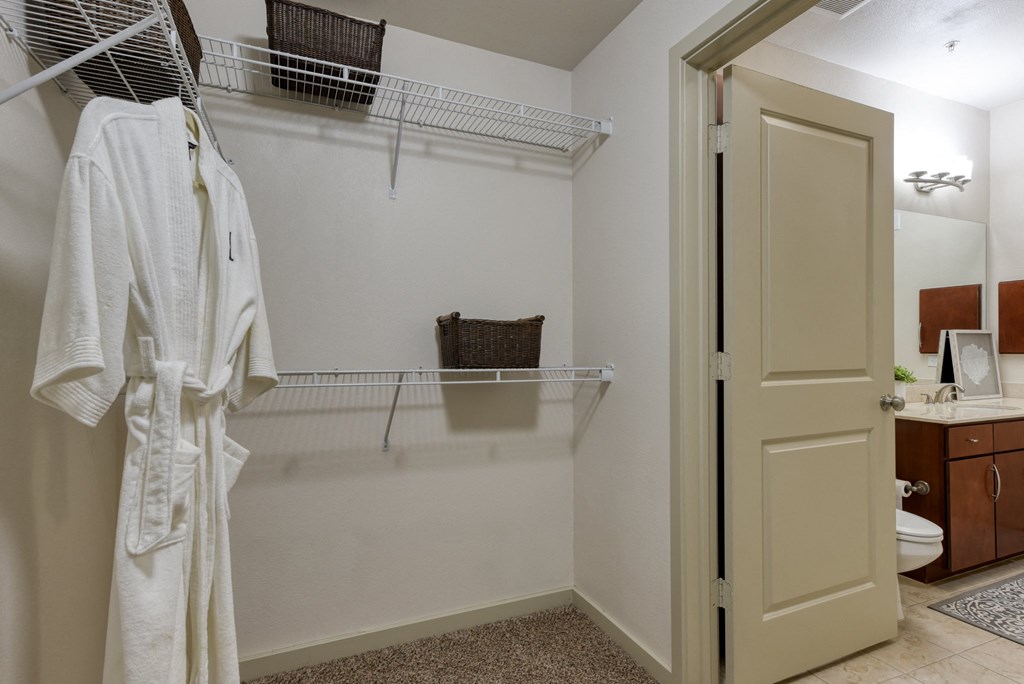 a bathroom with a shower and a towel rack and a toilet and a sink