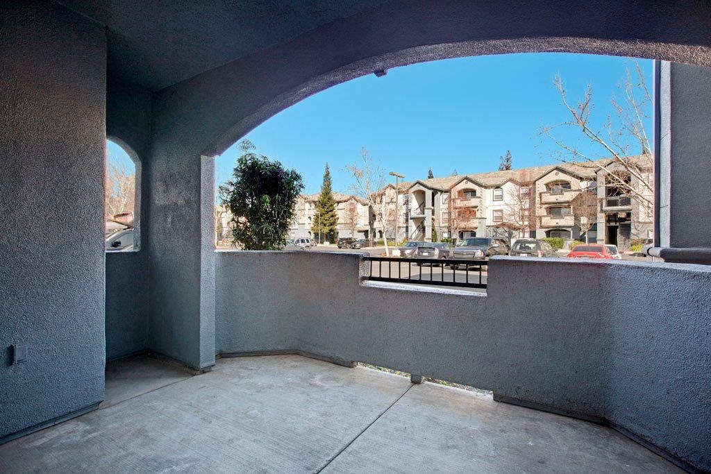 A balcony with a view of apartment buildings.