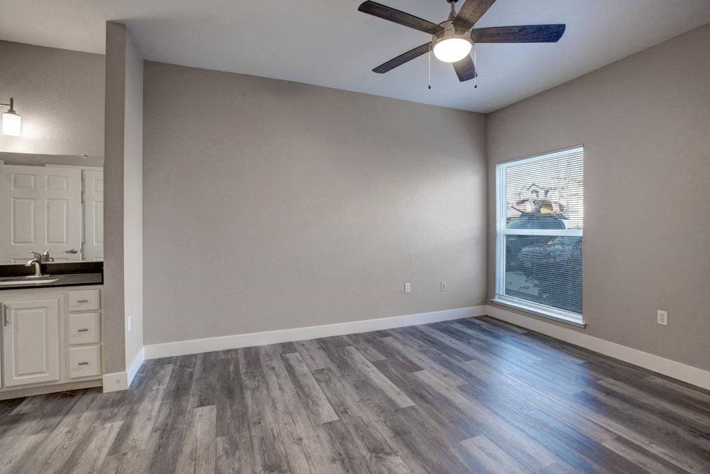 A room with a ceiling fan and a window showing a snowy landscape outside.