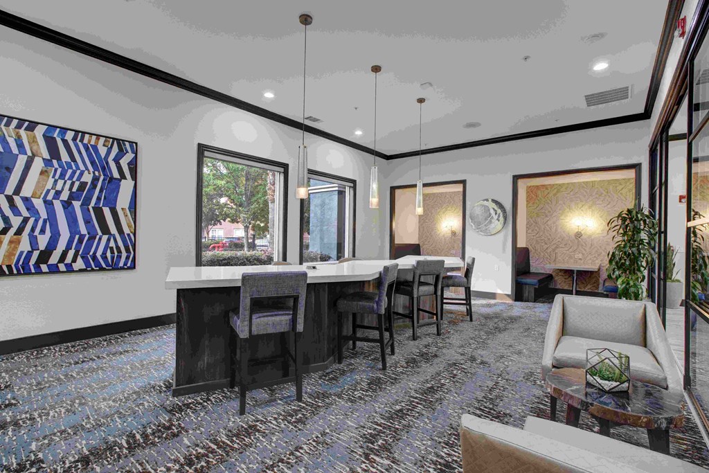 A dining room with a long table and chairs.
