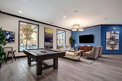 A pool table is in the middle of this room.