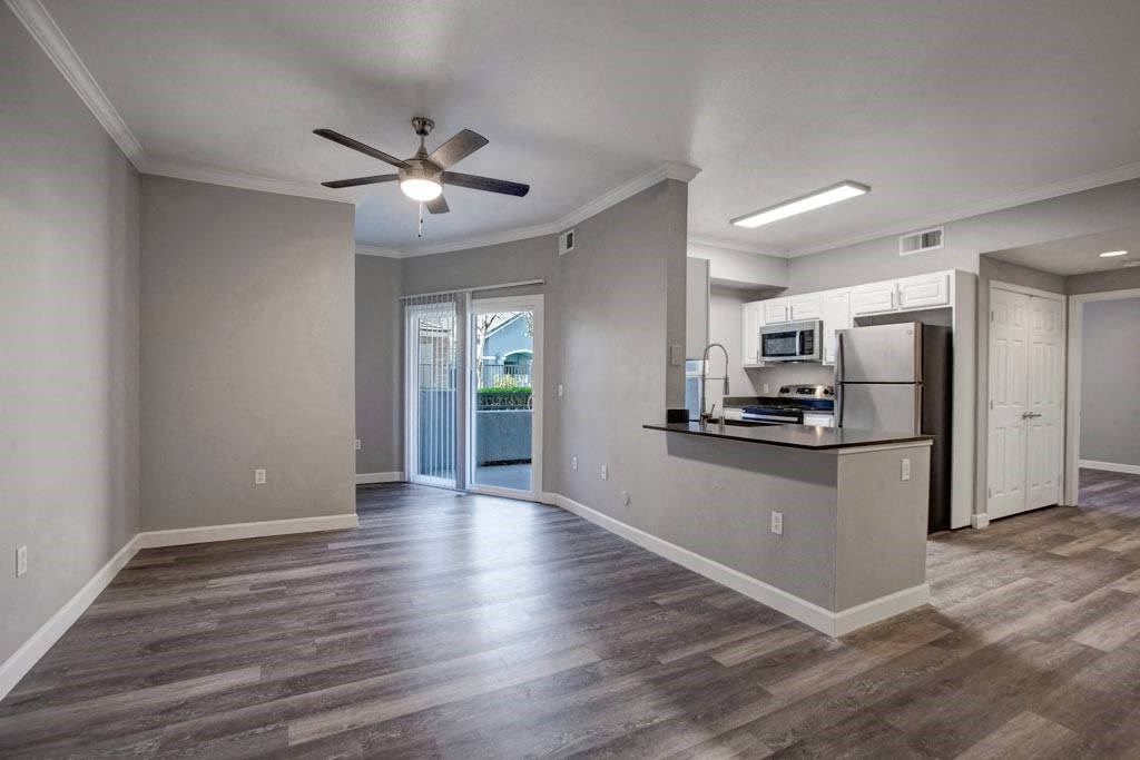 A kitchen area with a bar and a refrigerator.