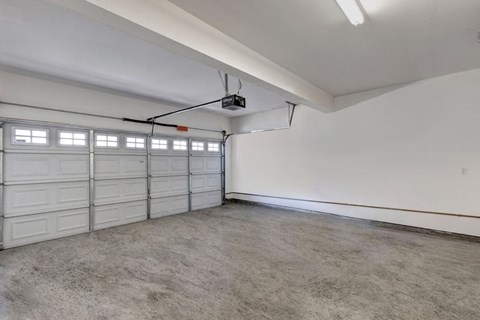 A spacious garage with a white ceiling and a concrete floor.