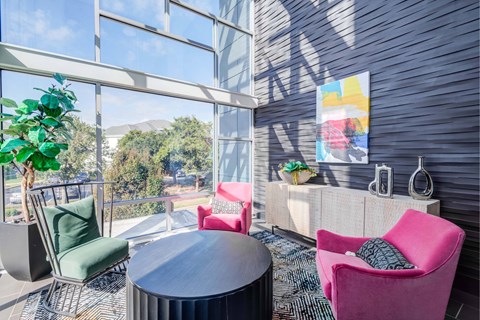 A room with a table and chairs with a view of the outside.
