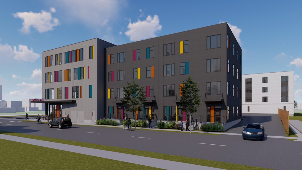 A modern building with a grey facade and colorful accents.