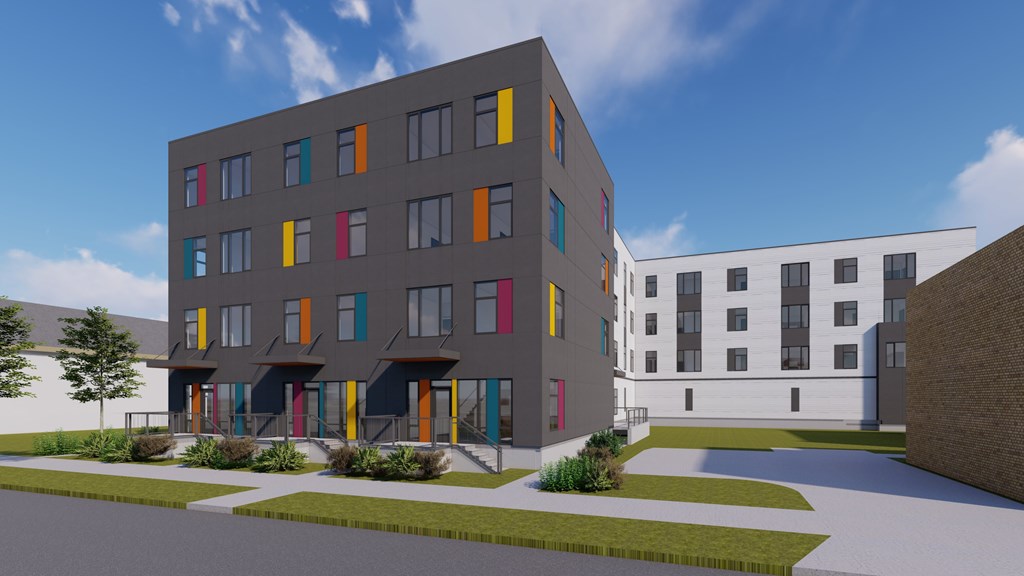 A modern building with a grey facade and colorful accents.