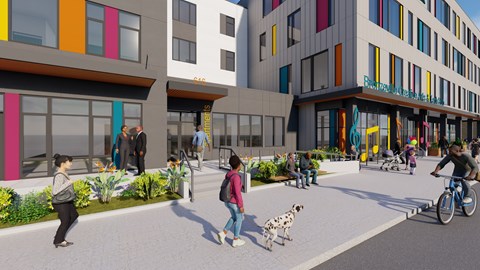 A group of people are walking and playing in a courtyard between buildings.