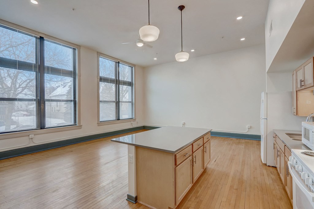 an empty kitchen with an island in the middle