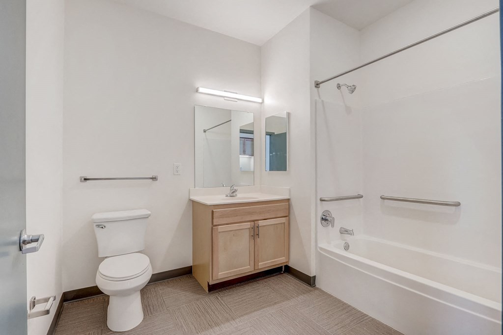 a bathroom with a toilet and a shower and a sink