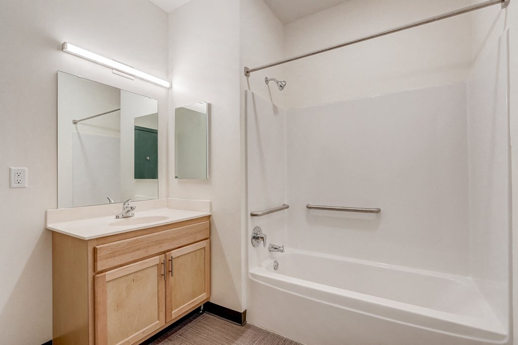 a bathroom with a shower and a sink and a mirror