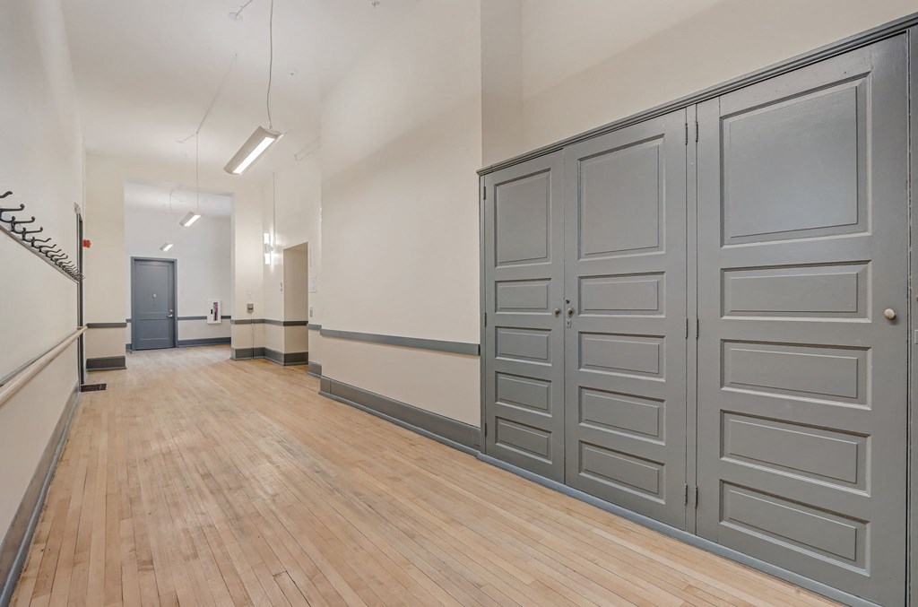 a large room with wood floors and gray doors
