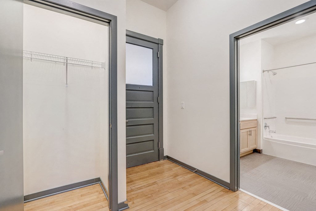 a bedroom with a closet and a door to a bathroom